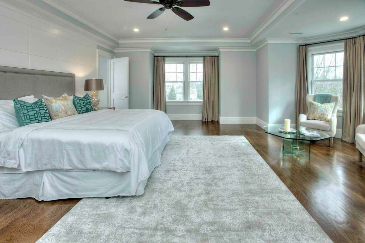 The master bedroom suite is quite large with a walk-in bay sitting area, a ceiling fan, an extra-large closet, and a lavish marble spa bath.