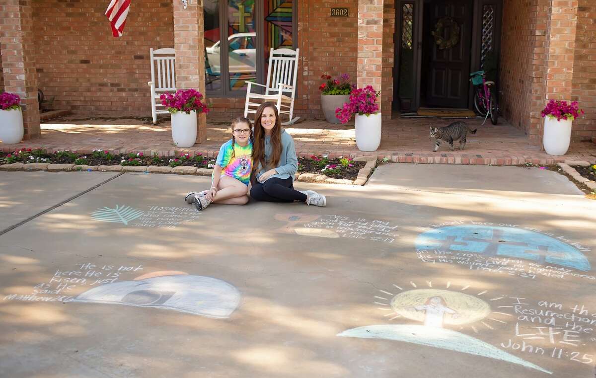 Mallory Buck and her 11-year-old daughter, Ellie, sit outside their home Monday afternoon. They created chalk art on the sidewalk for Easter.