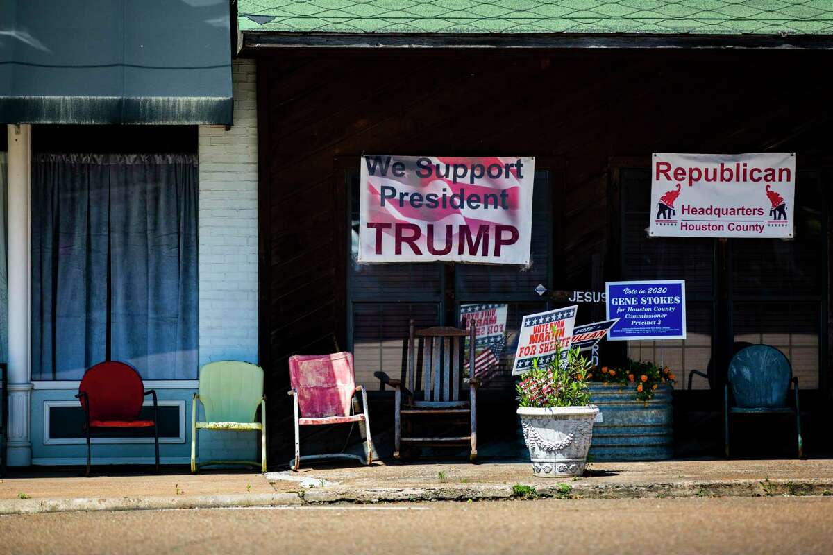 A sign supporting President Donald Trump hangs in front of the Republican Party headquarters in Crockett on Monday, April 13, 2020.