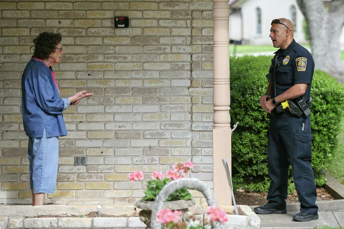 Windcrest Police Department patrolman Mark Dumas on Friday visits with a senior citizen as part of the department’s senior welfare check program that has officers conduct daily visits to elderly residents whose names have been submitted to the department for the routine check-ins.