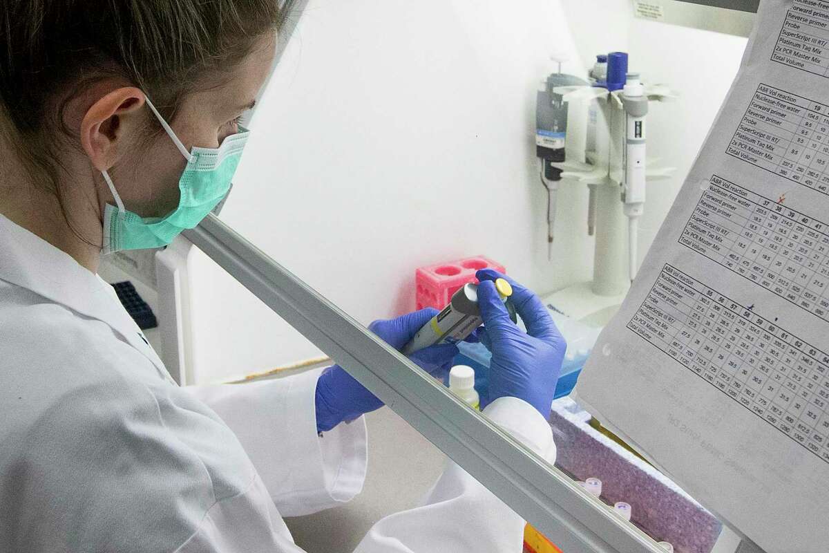 Ashlie Renner, research technician, prepares a Polymerase Chain Reaction tray while working in a lab on Thursday, April 9, 2020 at Baylor College of Medicine in Houston. BCM is working on an experimental therapy transfusing the blood plasma of people who’ve recovered from COVID-19 into patients fighting the disease.