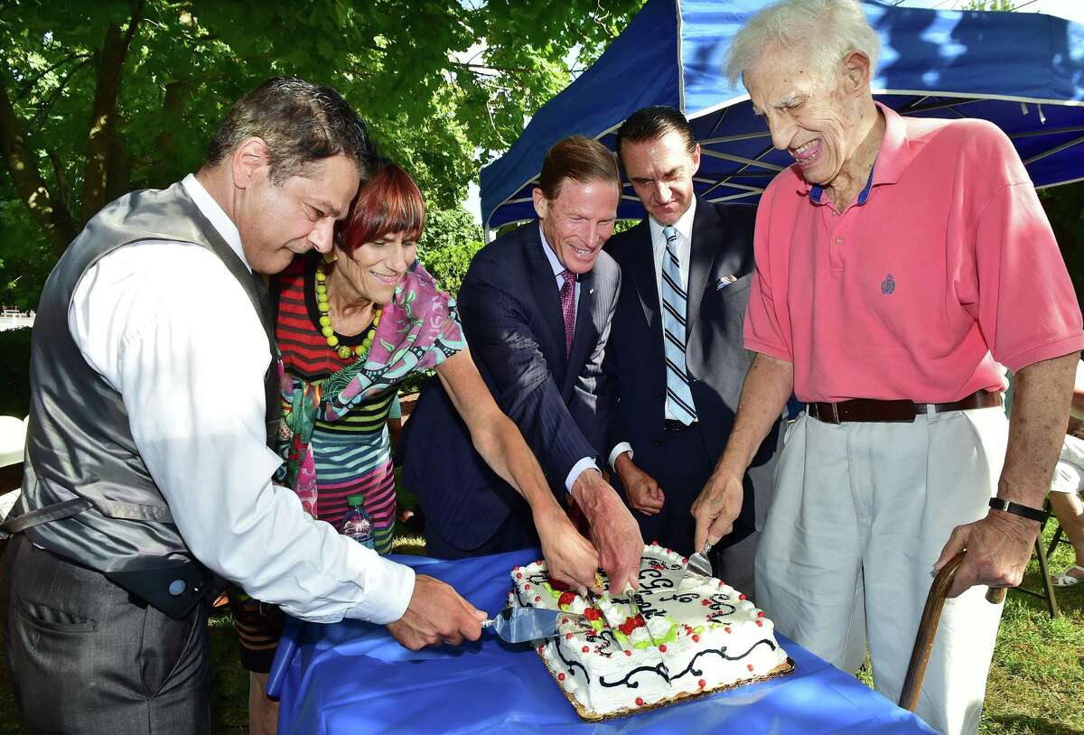 In this file photo, Ansonia Mayor David Cassetti, U.S. Rep. Rosa DeLauro, U.S. Sen. Richard Blumenthal, Gregory Stamos and Ted Vartelas cut the cake for the residents of lower Naugatuck Valley as Ansonia commemorates the 60th anniversary of the Great Flood of 1955, Wednesday, August 19, 2015, on the bank of the Naugatuck River at Vartelas Park on Olson Drive in Ansonia.