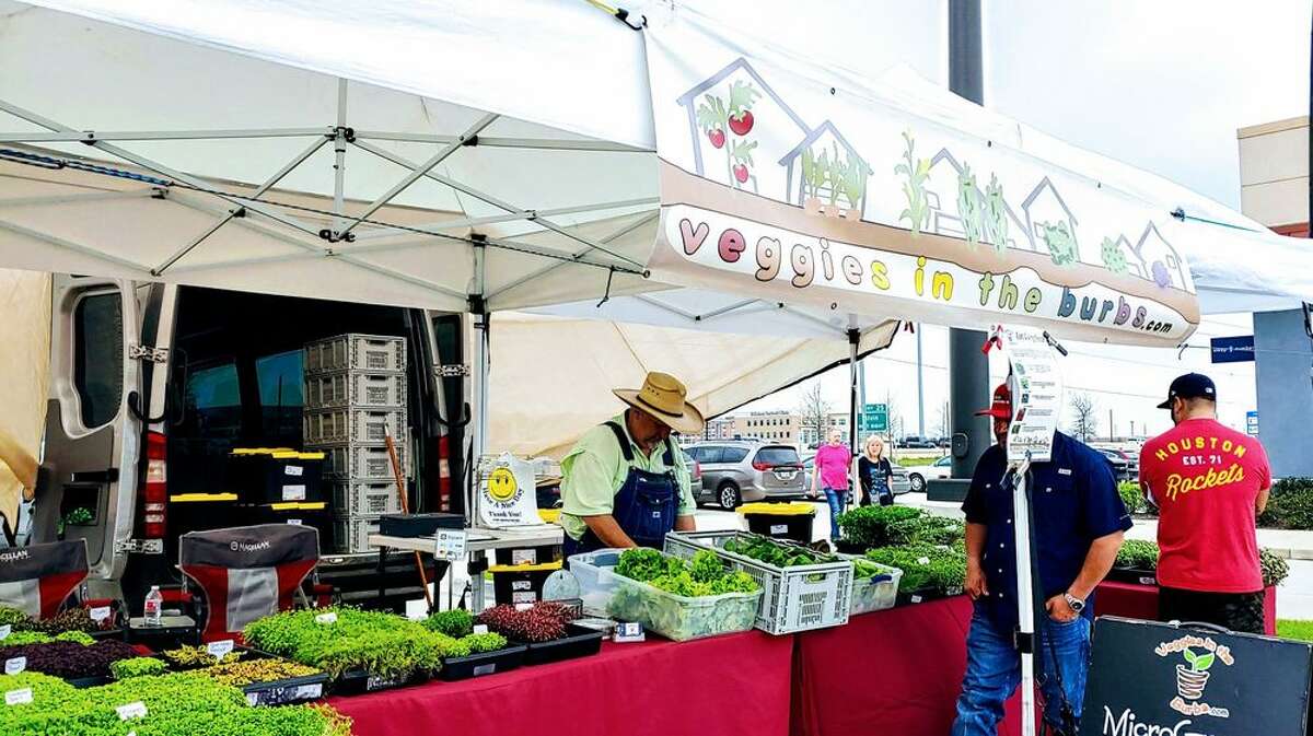 The market features vendors offering a variety of food including meat and produce.