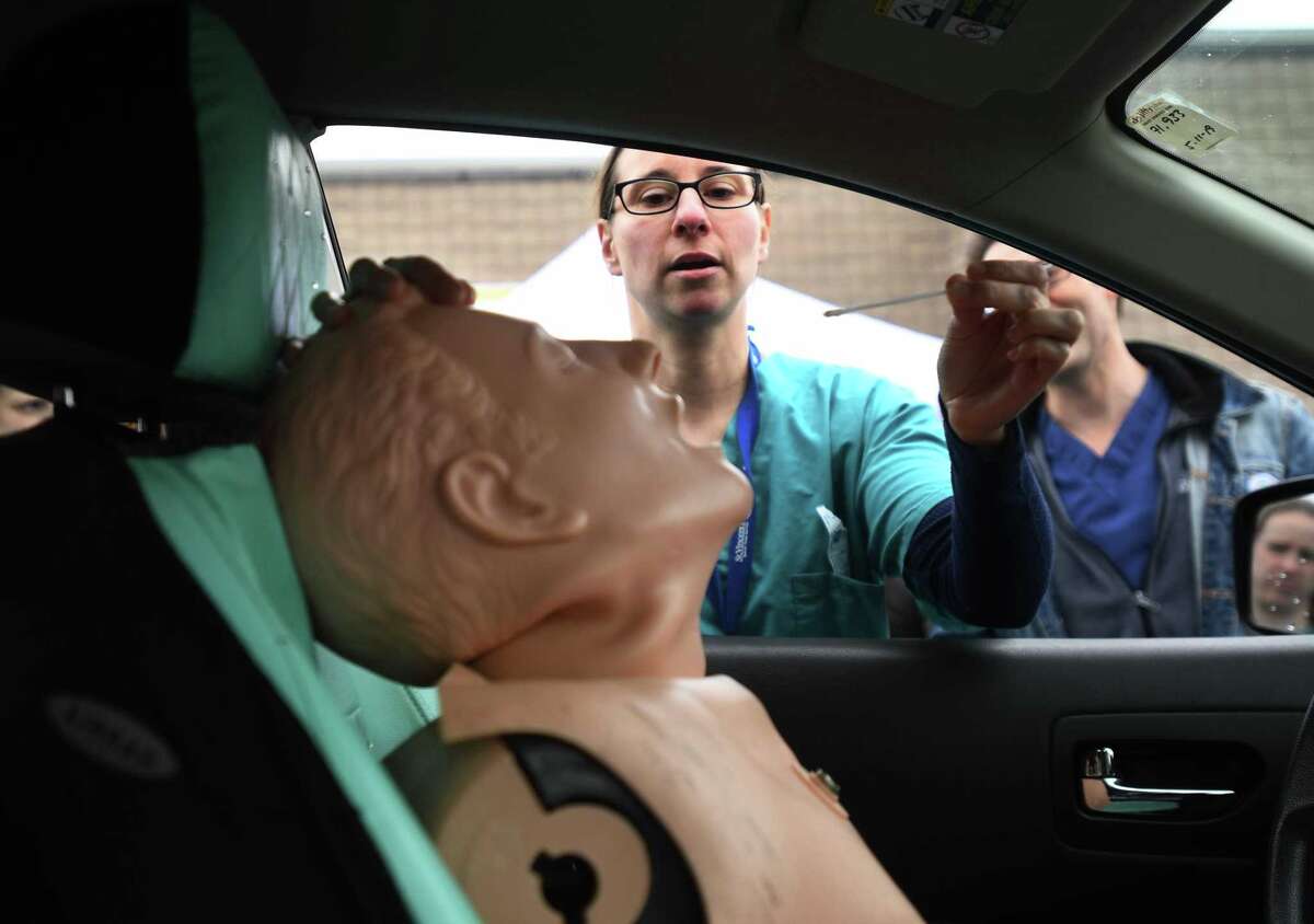 Nurse Michelle DiLorenzo, LPN, practices taking a nasal swab in preparation for drive through coronavirus testing at St. Vincent's Bridgeport Health & Wellness Center in Bridgeport, Conn. on Tuesday, March 17, 2020. Similar drive-through testing is also being done at PhysicianOne Urgent Care in Ridgefield.