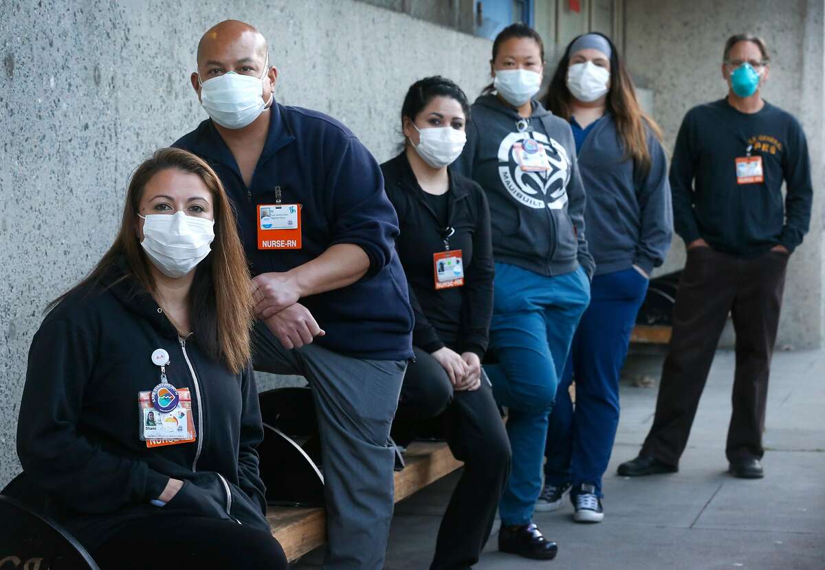 Shami Engel (left) gathers with colleagues outside of the psychiatric emergency department where they work as registered nurses in San Francisco, Calif. on Tuesday, April 14, 2020. With Engel is, from left, Michael Roxas, Nancy Gudino, Charlene Leung, Leticia Ornelas and Brian Saxon. The nurses may have been exposed to the COVID-19 coronavirus after a patient was brought into the ward on Saturday.