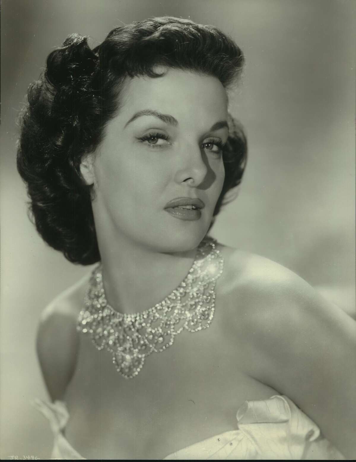 Jane Russell looks like a million and has a million in RKO Radio's extravagant Technicolor musical, "The French Line," in which she portrays the richest gal in Texas who searches for a man who loves her and not her bank balance. Gilbert Roland and Arthur Hunnicutt are co-starred in the Edmund Grainger production which features Marty McCarty, Joyce MacKenzie, Craig Reynolds and oodles of beautiful models and dancing girls. ...plays a rich Texan...