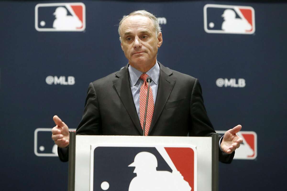 FILE - In this Nov. 21, 2019, file photo, baseball commissioner Rob Manfred speaks to the media at the owners meeting in Arlington, Texas. Major League Baseball is cutting the salary of senior staff by an average of 35% for this year and is guaranteeing paychecks to its full-time employees of its central office through May. Baseball Commissioner Rob Manfred made the announcement Tuesday, April 14, 2020. (AP Photo/LM Otero, File)
