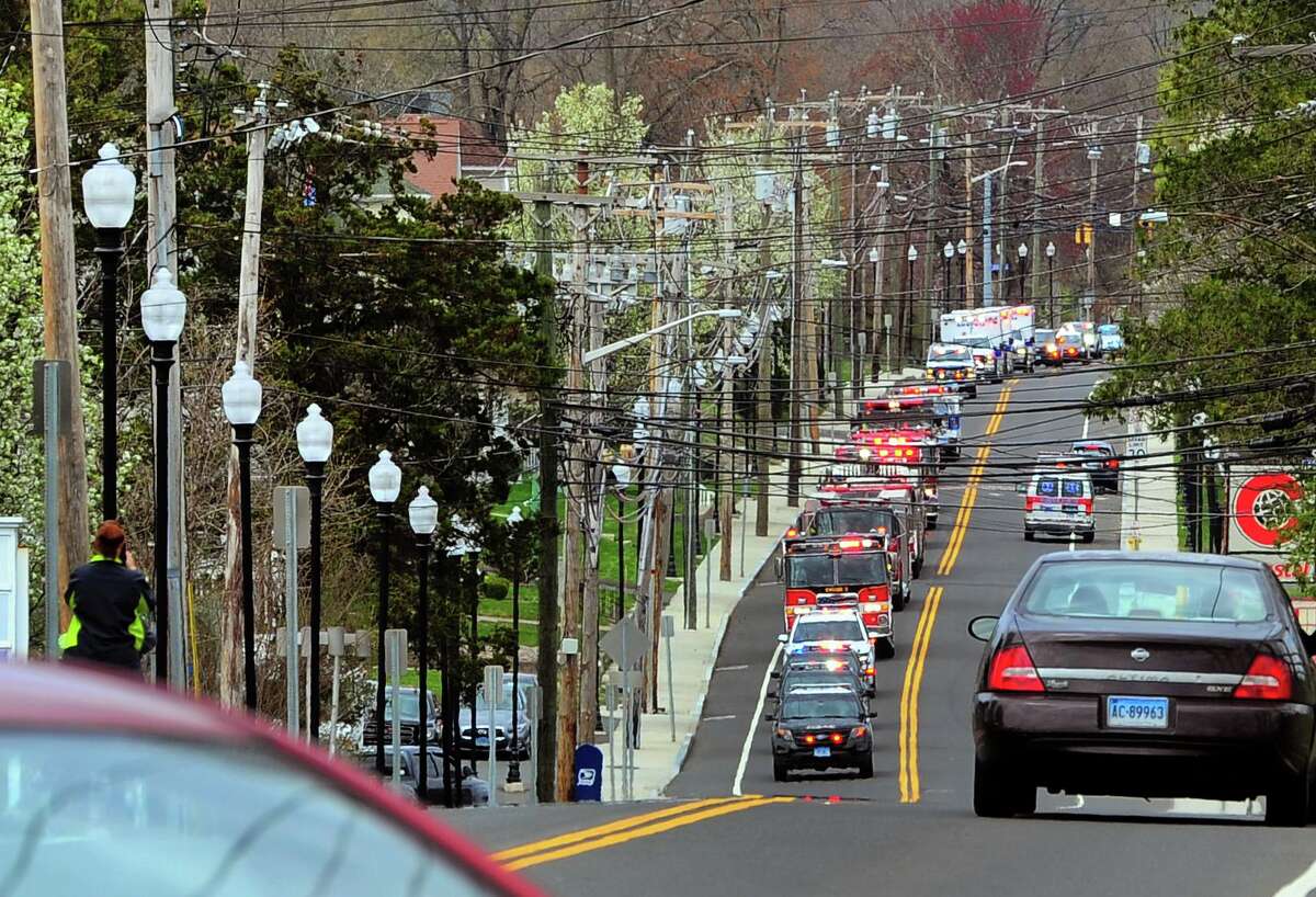 Dozens of fire, police, and EMS vehicles drive along Wakelee Ave to Griffin Hospital in Derby, Conn., on Tuesday Apr. 14, 2020. Vehicles gathered at Nolan Field in Ansonia and rode in a parade along Wakelee Ave and then stopped briefly at the hospital to greet workers.