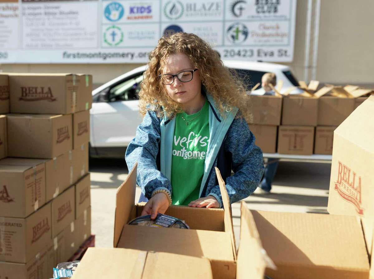 Karley Stanley, 14, assorts a boxed meal during a food drive at First Montgomery Baptist Church, Tuesday, April 14, 2020. Stanley began homeschooling before the COVID-19 pandemic.