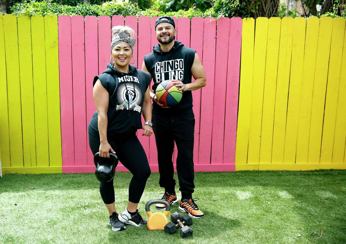 Comedian-rapper Chingo Bling and fitness-expert wife Marisol Herrera work out in the backyard of their Houston home.