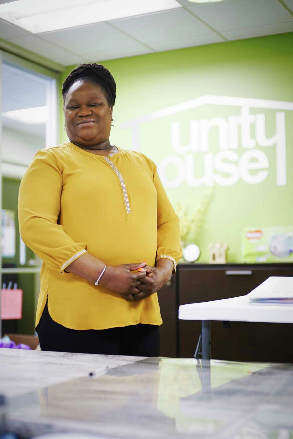 Pauline Glenn, a receptionist at Unity House poses for a photo at the reception desk on Wednesday, April 15, 2020, in Troy, N.Y. (Paul Buckowski/Times Union)