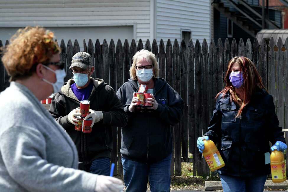 Volunteers from the Mechanicville-Stillwater Elks assist Regional Food Bank of Northeastern New York members in distributing food to Saratoga County residents during a drive-through food pantry event on Wednesday, April 15, 2020, at the Mechanicville-Stillwater Elks in Mechanicville, N.Y. (Will Waldron/Times Union)