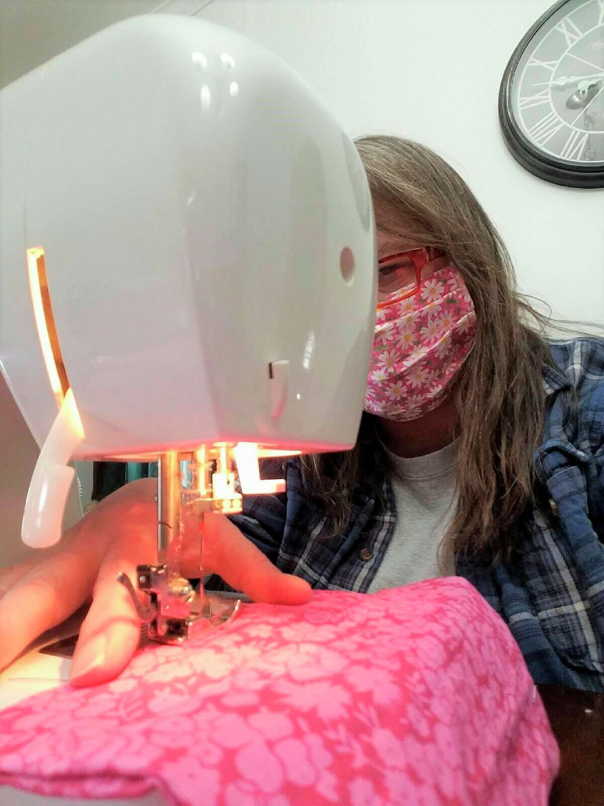 Pictured is Sharon Miller, sewing one of her face masks. She has sewn and donated more than 150 masks to local healthcare workers. (Courtesy photo)