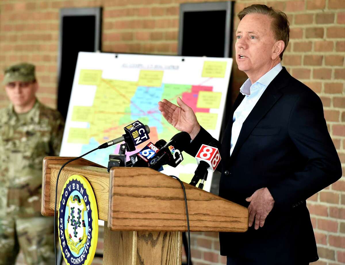 New Haven, Connecticut - Wednesday, April 01, 2020: Connecticut Governor Ned Lamont, right, holds a press conference after a tour of the Federal Emergency Management Agency 250-bed medical field hospital Wednesday for non-coronavirus patients staged in the Southern Connecticut State University Moore Field House in New Haven by 75 members of the Connecticut National Guard's 1-102nd Infantry. The site is intended to treat non-COVID-19 patients so there will be more hospital beds people who are impacted by COVID-19 / Coronavirus.