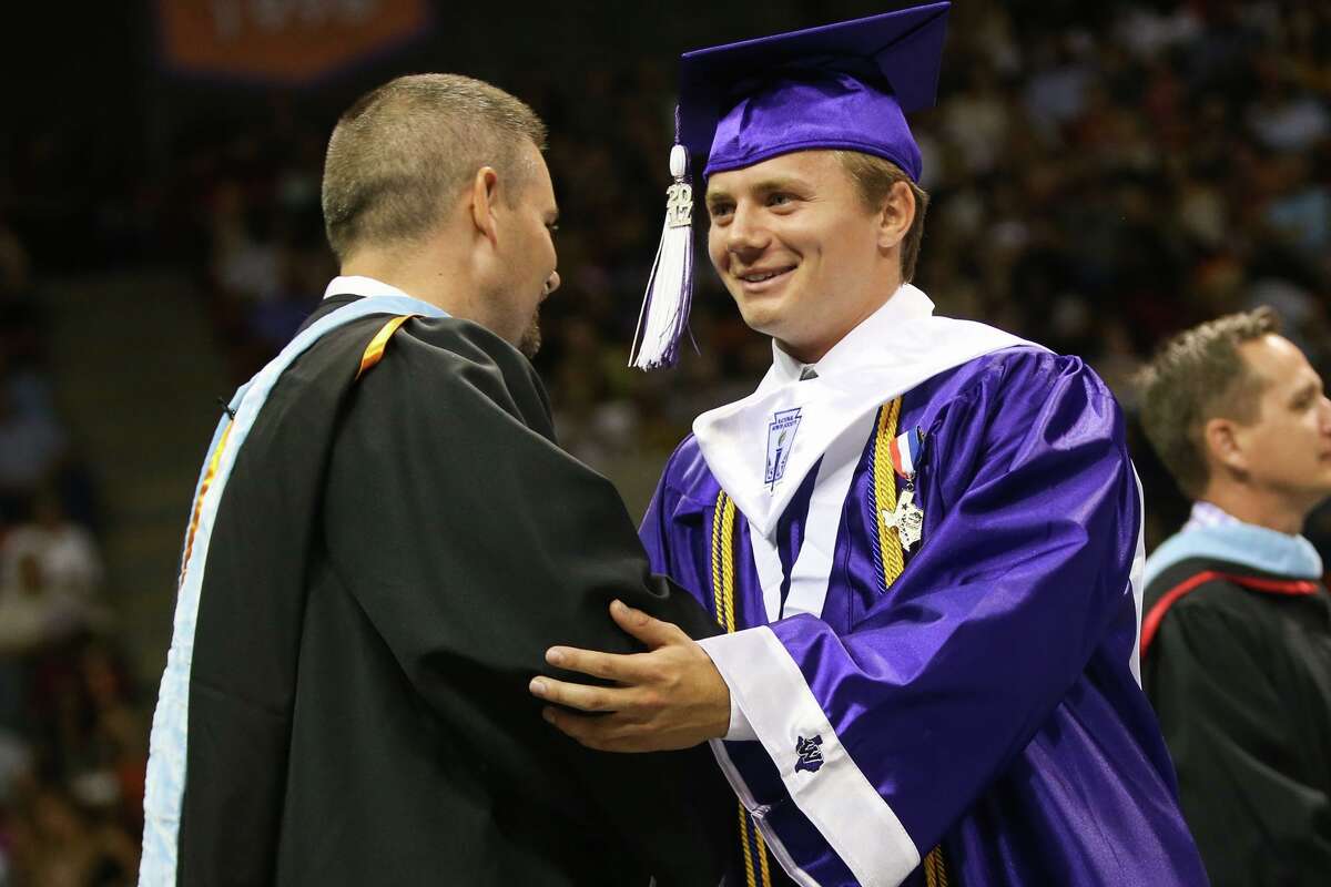 Salutatorian Joshua Matthews shakes hands with Principal Travis Utecht during the Willis High School commencement ceremony on Friday, May 26, 2017, at Sam Houston State University.