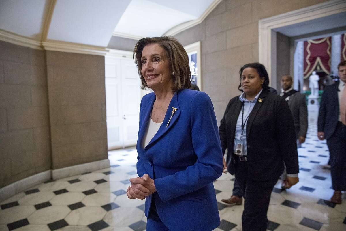 In this March 27, 2020, photo, House Speaker Nancy Pelosi of Calif., walks to her office after signing the Coronavirus Aid, Relief, and Economic Security (CARES) Act on Capitol Hill in Washington. President Donald Trump wants to spend $2 trillion on infrastructure projects to create jobs and help the collapsing economy rebuild from the coronavirus' stunning blows. Pelosi says that seems about right. Sounds like the prelude to a bipartisan deal. Except that when it comes to trying to upgrade the country's road, rail, water and broadband systems, Washington frequently veers off the tracks — usually over the bill's contents and how to pay for it. (AP Photo/Andrew Harnik)
