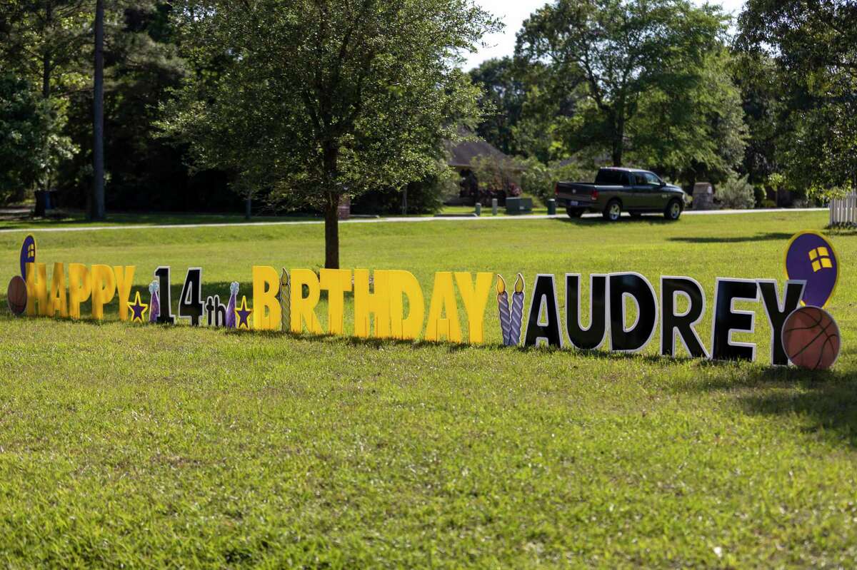 A sign is posted wishing Audrey Hammons a happy 14th birthday in front of her home in Crown Oaks in Montgomery, Tuesday, April 14, 2020. Hammons was unable to host a traditional birthday celebration due to COVID-19.