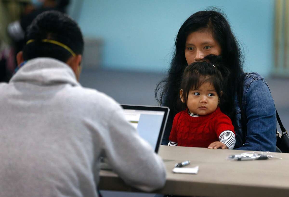 Odilia Ramirez and her daughter Keyli Garcia, 1, meets with a volunteer at a U.S. census count focused on residents who speak Mam, an indigenous Mayan language spoken by hundreds in the community, in Oakland, Calif. on Saturday, April 11, 2020.