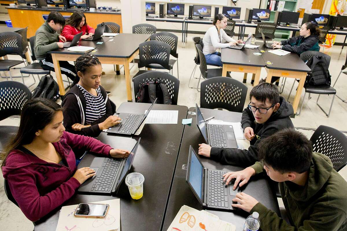 (From left, clockwise) Students Yocelyn Tula, 17, Olivia Mitchell, 17, Sherman Chen, 17 and Jinan Yu, 16, work to research the country of South Korea after Health Science teacher Evan Mundahl assigned his students countries affected by the Coronavirus as part of a group project in his first period class at Phillip and Sala Burton Academic High School in San Francisco, Calif. Wednesday, March 11, 2020. Students broke into groups and were assigned a country affected by the Coronavirus, then asked to research statistics, health protocol and find the most recently updated information in their specific country surrounding the outbreak.