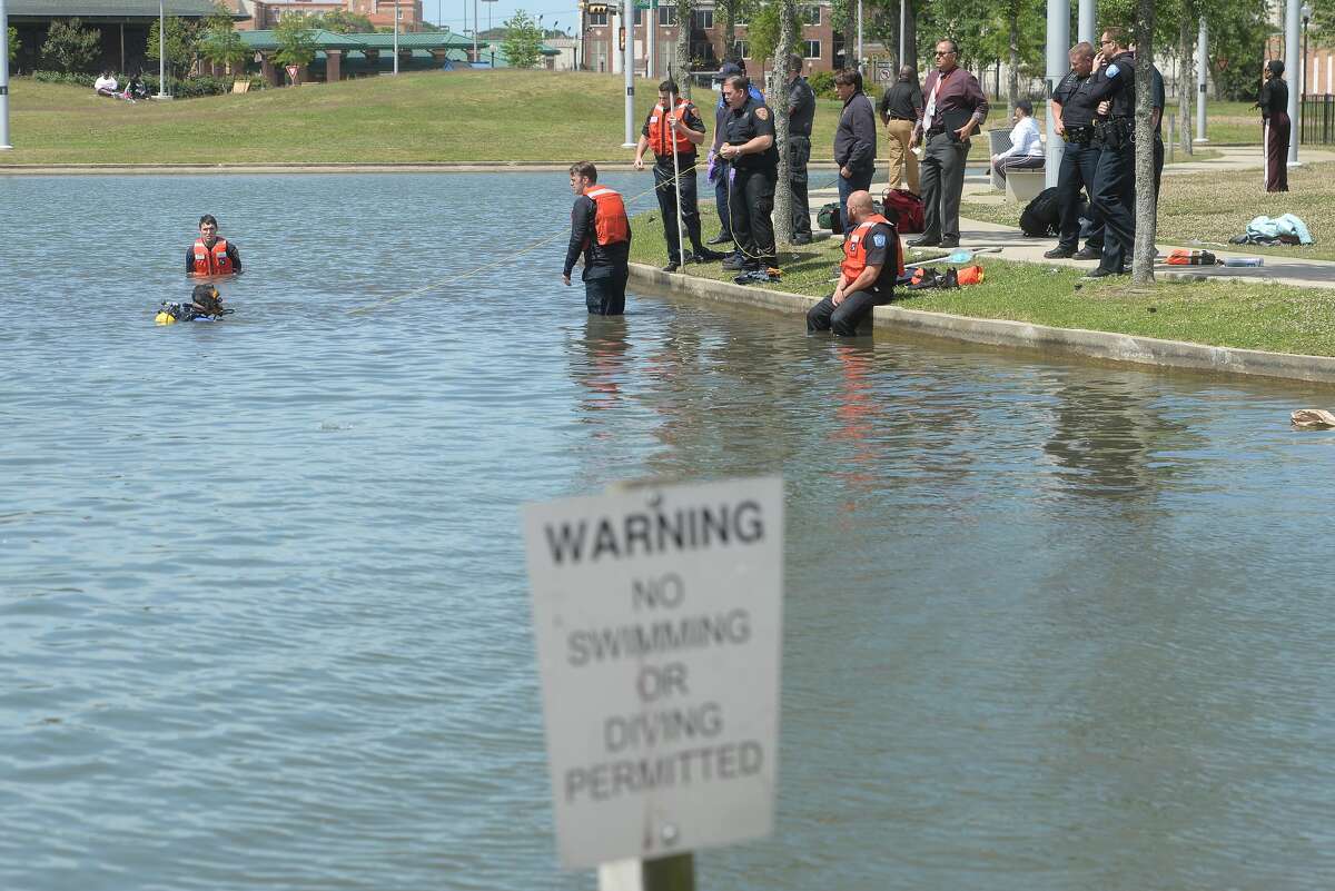 Emergency crews and the dive team work the scene at the Lake at the Event Centre, where a child and adult, who is tentatively identified as the boy's mother, drowned Wednesday. According to Haley Morrow, initial reports indicate the boy fell into the water, and the mother then went in after him. The mother was revived by paramedics as the dive team continued scouring the pond for the three-year-old boy, who was brought up by a diver. Crews continued CPR on the little boy, who was also taken to an ambulance for transport to the hospital. Photo taken Tuesday, April 14, 2020 Kim Brent/The Enterprise