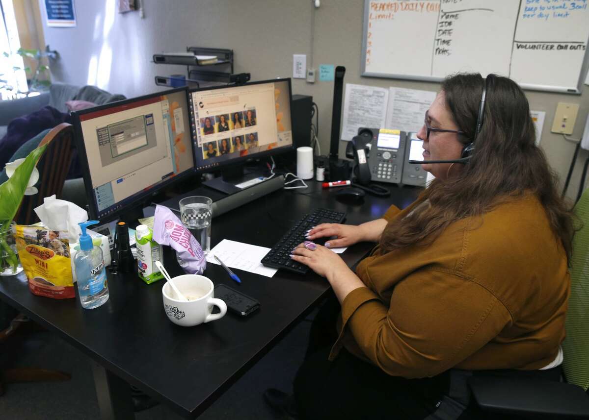 Kate Eisler speaks to a client calling a suicide hotline at Crisis Support Services of Alameda County in Oakland, Calif. on Tuesday, April 14, 2020. Calls to the suicide prevention hotline have increased 100 percent as the coronavirus pandemic continues.