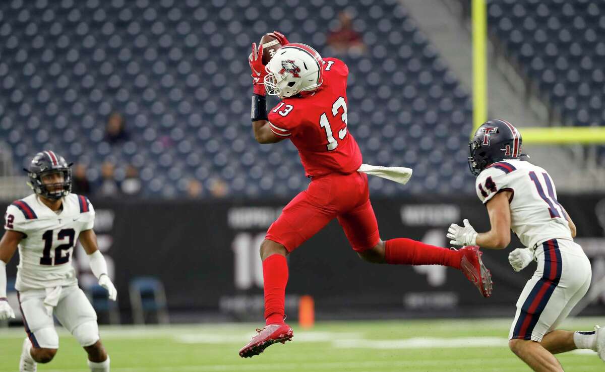 Atascocita Eagles Landen King (13) catches a pass defended by Tompkins Falcons Colby Huerter (14) during the first half of the high school football playoff game between the Tompkins Falcons and the Atascocita Eagles at NRG Stadium in Houston, TX on Saturday, November 30, 2019. The Eagles lead the Falcons 35-3 at halftime.