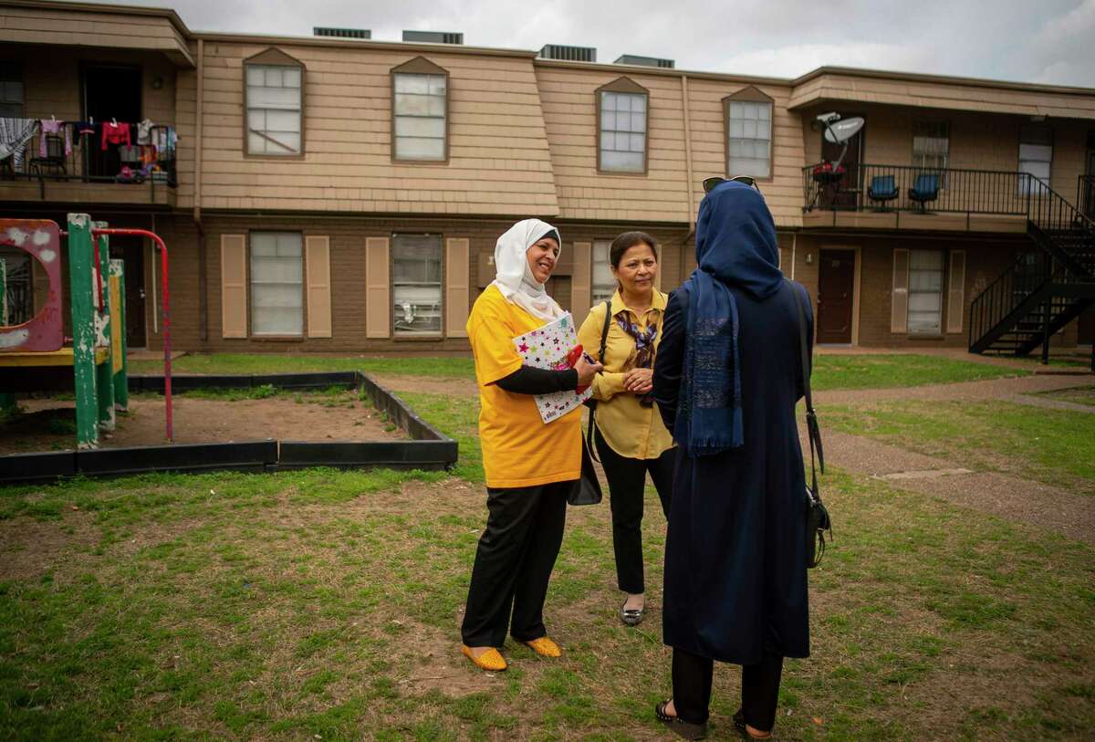 Halah Abboodm and Aisha Siddiqui, the founding director of Culture of Health-Advancing Together (CHAT), talk to one of Abboodm's neighbors about the coming 2020 Census, Monday, March 2, 2020, at the Ashford Crescent Oaks apartments in Houston's Gulfton neighborhood. Abboodm, a new U.S. citizen who is originally from Iraq, has been working to get community members to sign a pledge card that they will fill out the 2020 Census.