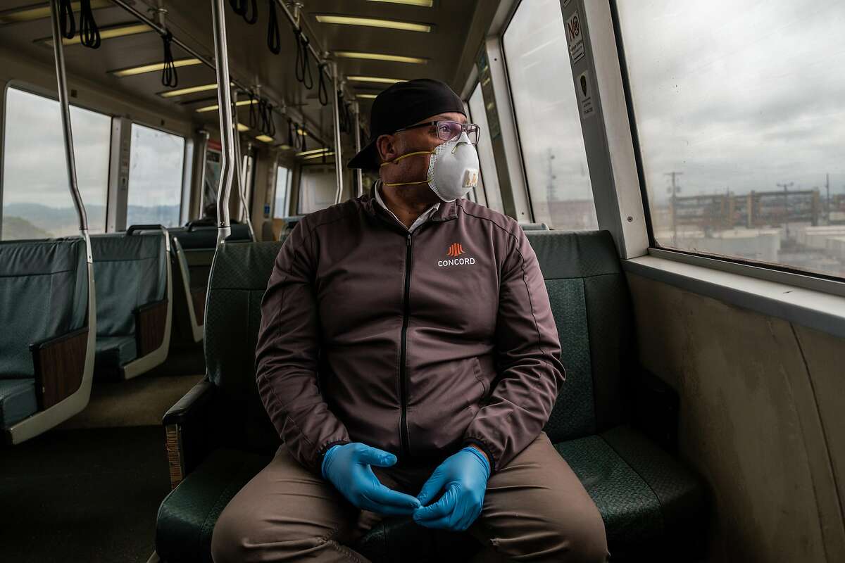 Chase Bronson who is a fire systems inspector and therefore considered an essential service worker rides BART in San Francisco, Calif. on Thursday April 16, 2020.