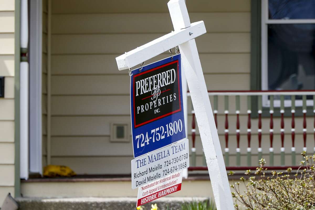 A real estate company sign marks a home for sale, Thursday, April 16, 2020, in Harmony, Pa. (AP Photo/Keith Srakocic)