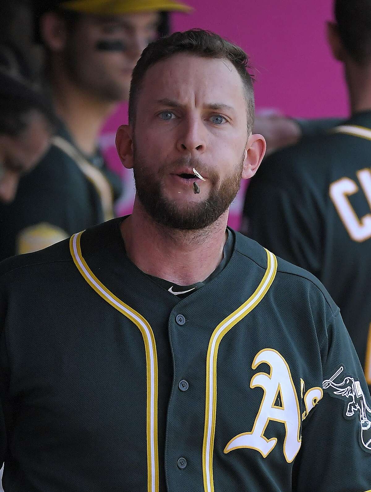 Oakland Athletics' Jed Lowrie spits seeds in the dugout during the first inning of a baseball game against the Los Angeles Angels Sunday, Aug. 12, 2018, in Anaheim, Calif. (AP Photo/Mark J. Terrill)