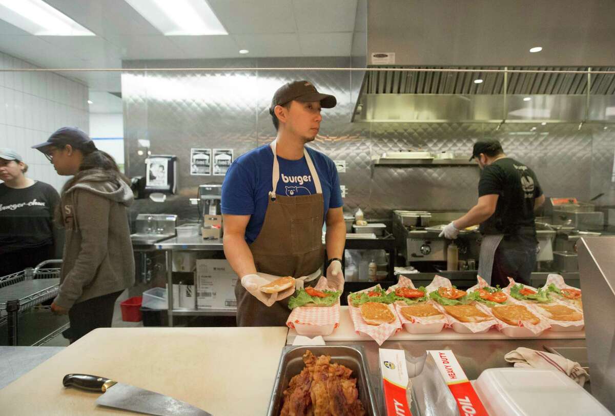 Burger-Chan Co-Owner and Chef Willet Feng works on an order Thursday, April 16, 2020, at Greenway Plaza in Houston.