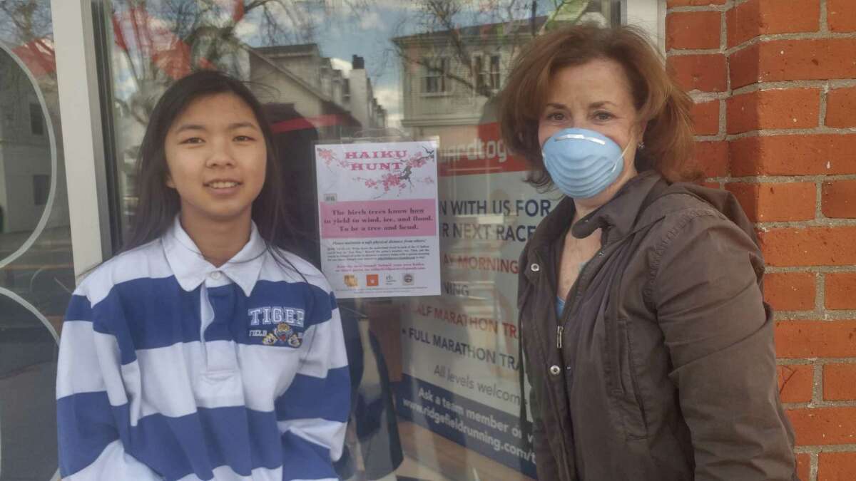 Ariana diLaura and her mother, Jennifer, a Ridgefield Arts Council member spent an afternoon hanging "hint" posters for the Haiku Hunt currently underway downtown. The activity was designed to get families out of the house and into the fresh air.