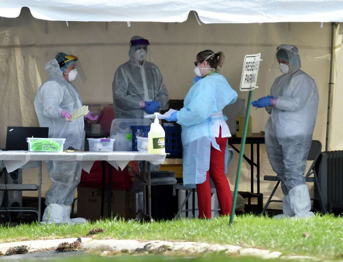 Healthcare workers staff a walk-up coronavirus testing site on Friday morning, April 17, 2020, outside the Whitney Young Health Center in Albany, N.Y. (Will Waldron/Times Union)