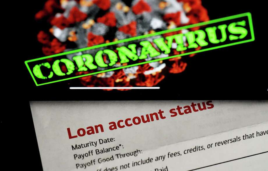 In this photo illustration, a loan statement account status is displayed next a iPhone screen behind reading "coronavirus" on April 16, 2020, in Arlington, Virginia. - The $349 billion cap for small business loans for the coronavirus stimulus was reached on April 16, 2020, taking less than two weeks to run out. (Photo by Olivier DOULIERY / AFP) (Photo by OLIVIER DOULIERY/AFP via Getty Images) Photo: OLIVIER DOULIERY / AFP Via Getty Images / AFP or licensors
