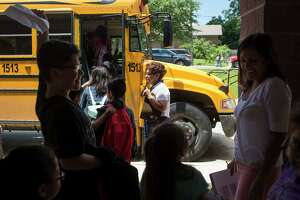 Teresa Guerrero helps students onto the bus on her last day of school before retiring in 2016 from Gilbert Elementary School in Harlandale ISD, where she taught for 40 years. Gov. Greg Abbott on Friday ordered school districts to keep their campuses closed for the rest of the semester.