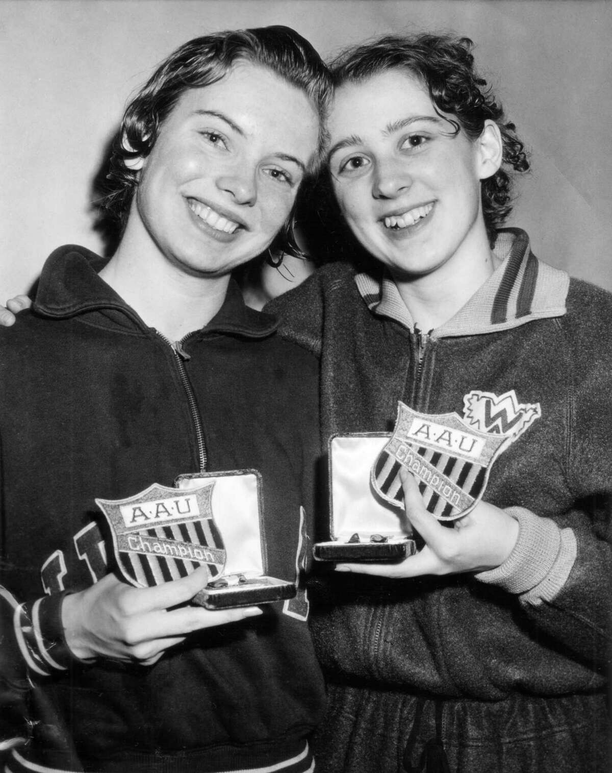 Carin Cone, left, of Ridgewood, N.J. and Nancy Ramey, Washington Athletic Club of Seattle as they pose with their awards for setting new AAU and American records in the final night of the Women's National AAU Indoor Swimming meet in Dallas, Texas, April 12, 1958.