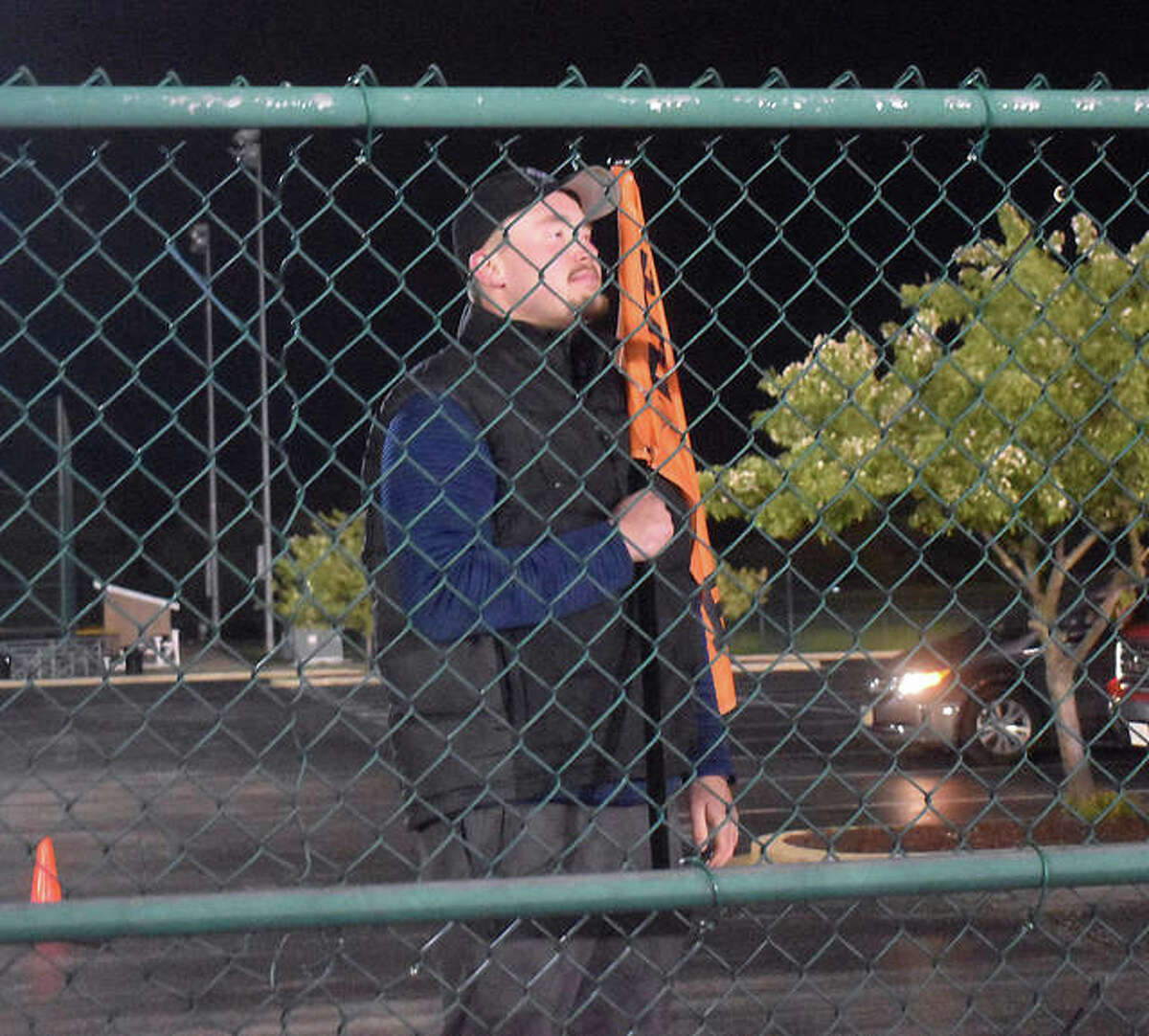 Edwardsville senior Jacob Kitchen looks at the football field from behind the gate in the parking lot Friday. Reames would have been in the middle of his baseball season. The District 7 Sports Complex was lit up Friday night in honor of the senior class. At 8:20 p.m. (20:20 military time), the lights were turned on for 20 minutes in honor of the seniors, who will end their prep days at home with schools being closed for the remainder of the academic year. A handful of seniors watched from the parking lot a safe distance away from each other. The other Southwestern Conference school, along with many throughout the state, took part in the event.