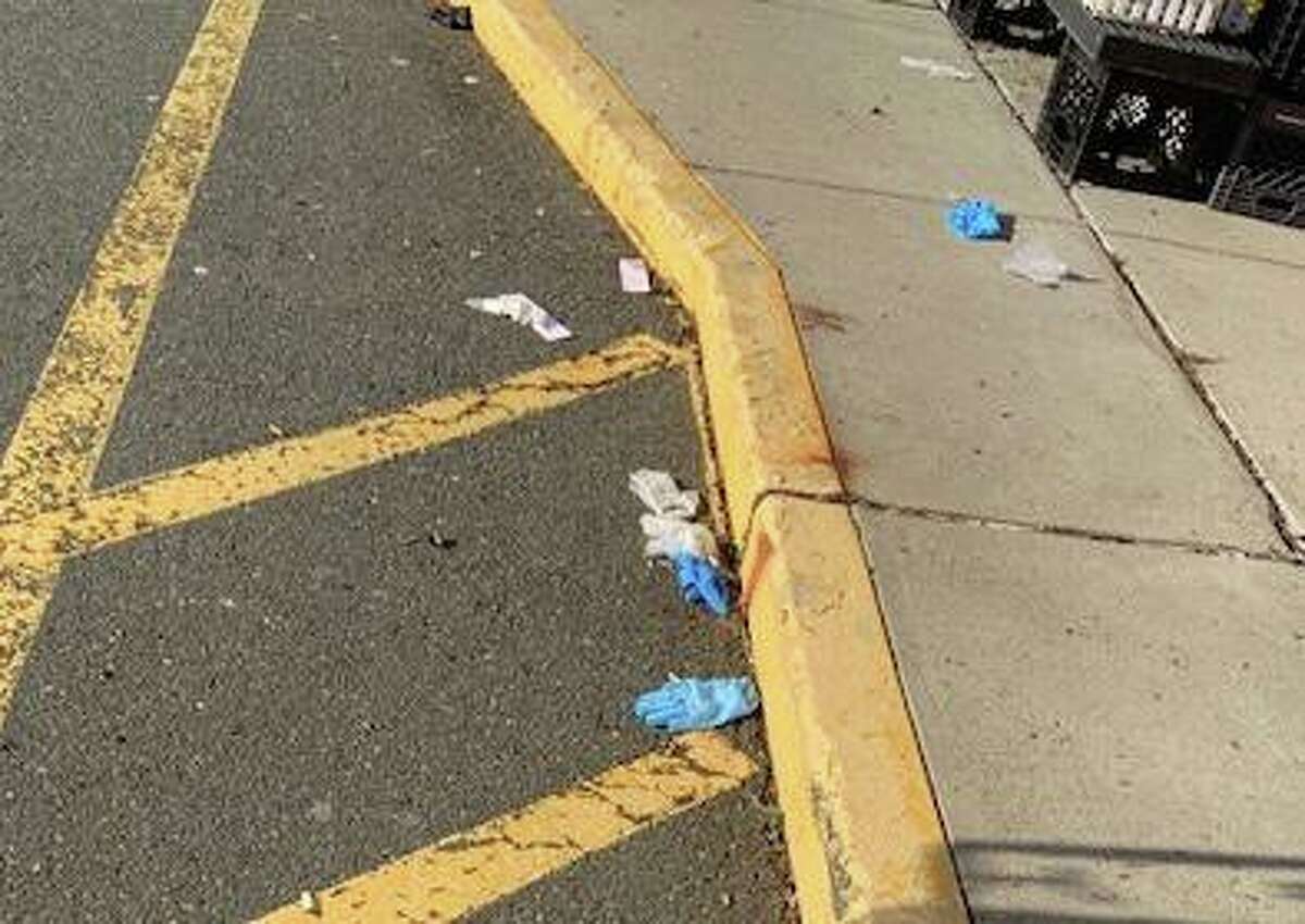 Gloves dropped on the ground outside Ridgefield's Stop and Shop will have to be cleaned up by workers.