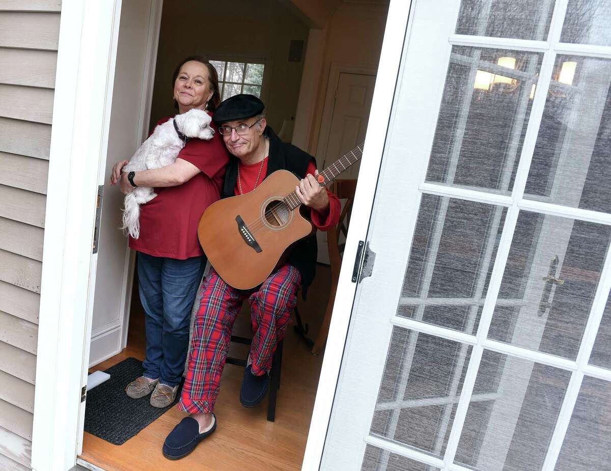 Blues guitarist Tom Crivellone with his wife, Sherrill, and their dog, Gracie, at their home in Weston on Saturday. April 18, 2020.