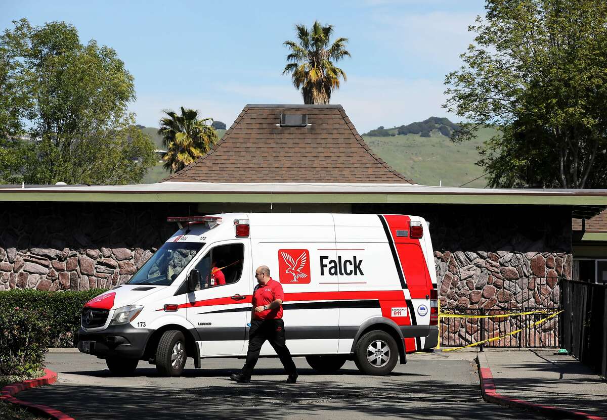 A Falck team prepares to leave after dropping off a patient at Gateway Care and Rehabilitation on Wednesday, April 15, 2020, in Hayward, Calif. The facility currently has eleven COVID-19 related deaths with dozens of staff members and patients infected with the novel coronavirus.
