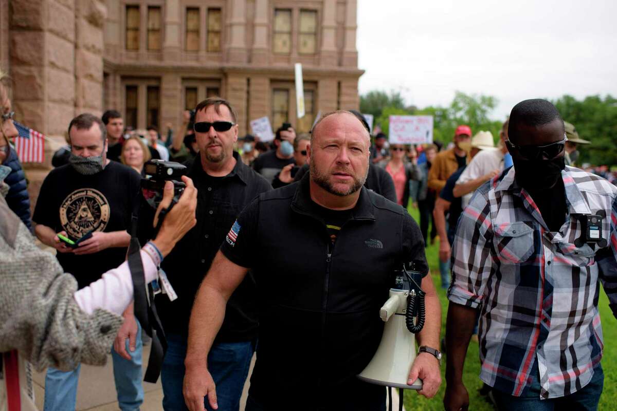 Infowars host Alex Jones marches with protesters during the "Reopen America" rally on April 18, 2020 at the State Capitol in Austin, Texas. (Photo by Mark Felix / AFP)