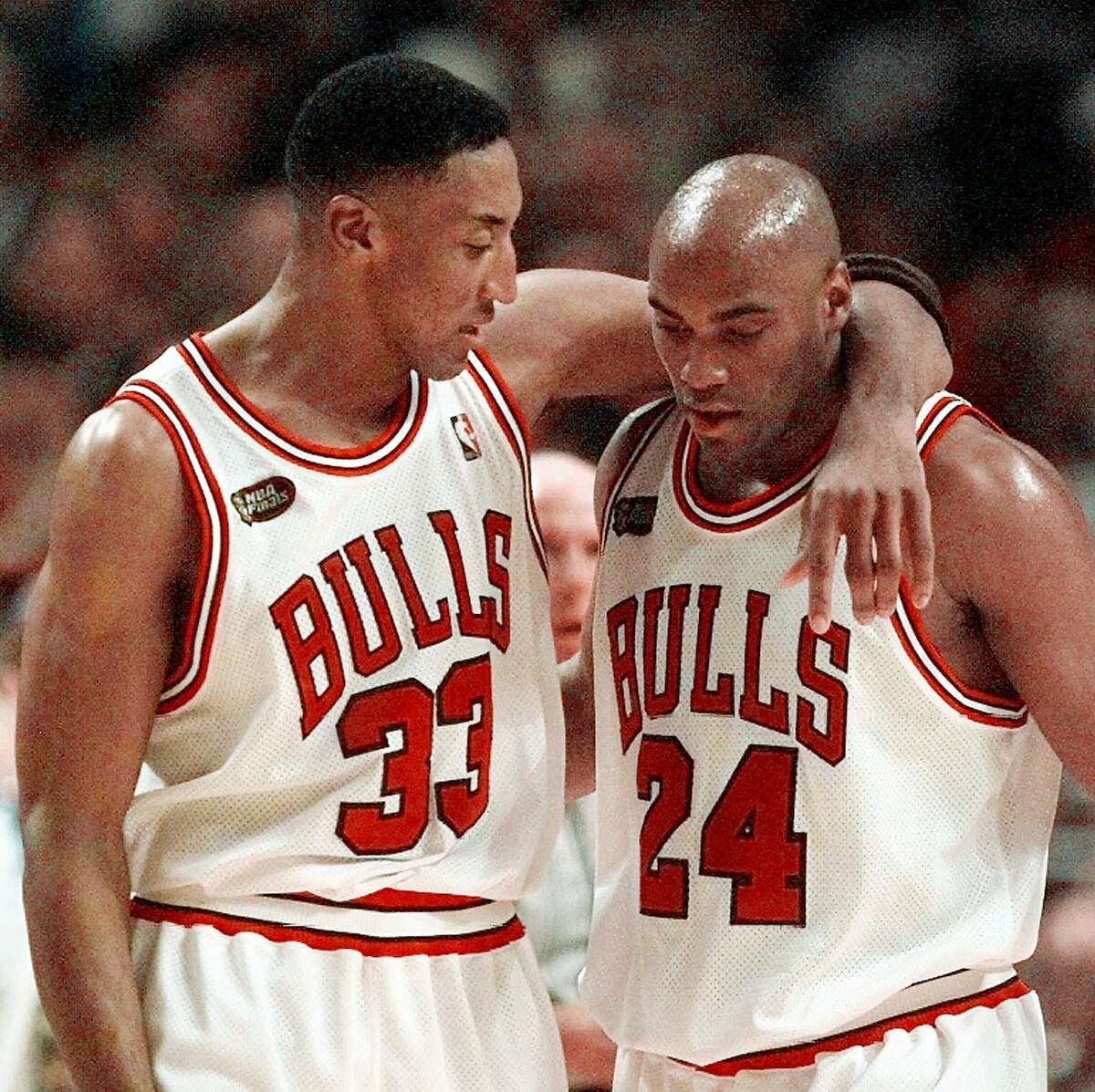 Chicago Bulls' Scottie Pippen (33) speaks with teammate Scott Burrell during the second half of the Bulls' 96-54 blowout of the Utah Jazz in Game 3 of the NBA Finals Sunday, June 7, 1998, in Chicago. (AP Photo/Michael S. Green)