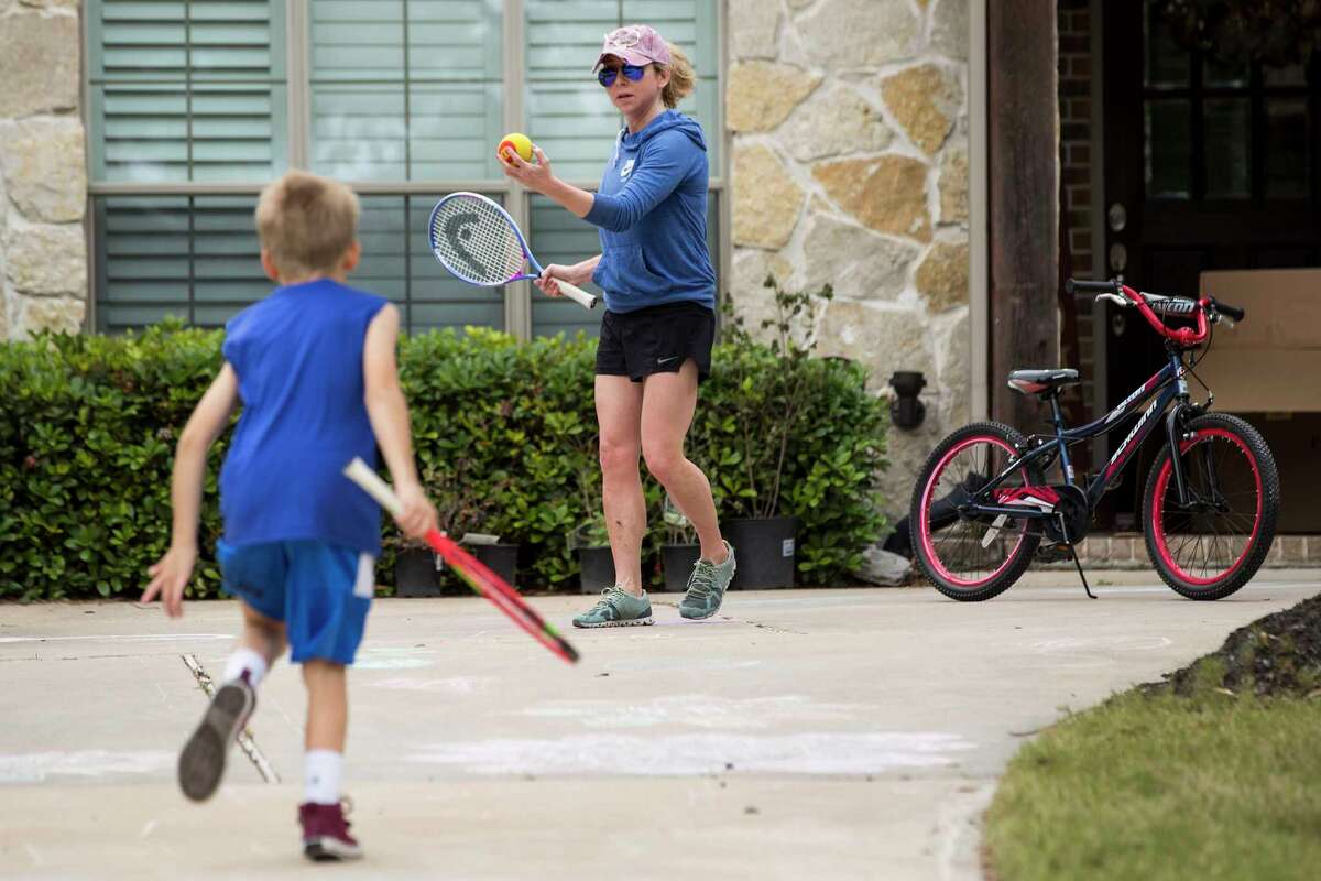 Meagan Clanahan plays outside with her son Ryan as they take a break from being indoors due to coronavirus on Friday, April 3, 2020 in Katy. During the past few years, children have dealt with major disruptive events like Harvey, Imelda and now COVID-19. Clanahan said she and her husband take time in the afternoons to play outside with their 9-year-old twins to help with their kids' anxiety.