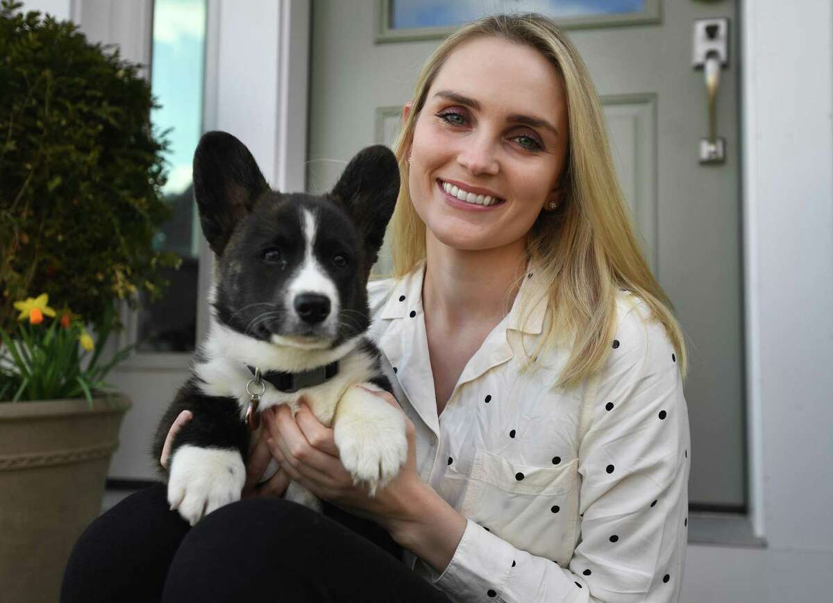 Dr. Taylor Purvis, with Geraint, her Welsh corgi puppy, at her home in Milford, Conn. on Wednesday, April 15, 2020. The dog is featured in Purvis' new children's book, Jasper and Tabitha Play a Trick on the Coronas, which helps educate children about the coronavirus.