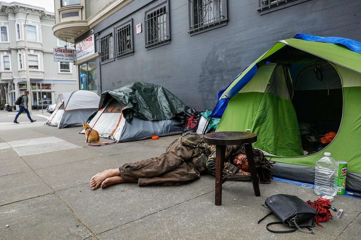 Damian William Pierce rests outside his tent on Waller Street on Sunday, April 19, 2020 in San Francisco, California.