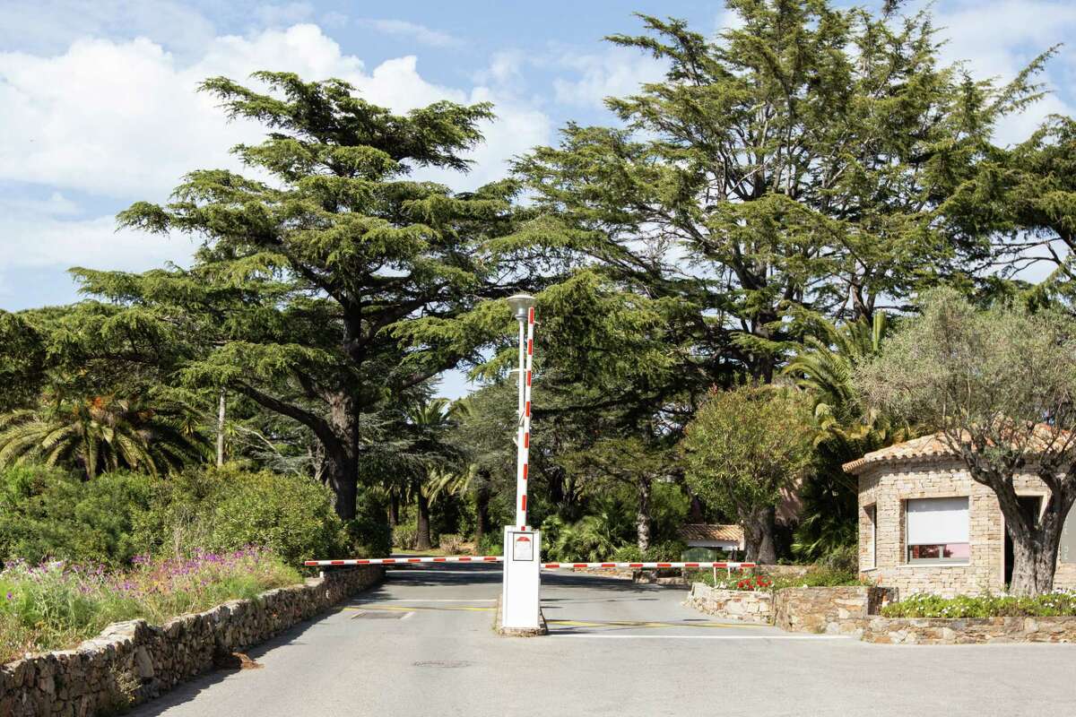 The entrance of Les Parcs de Saint-Tropez is protected by a security fence, gatehouse and guard..