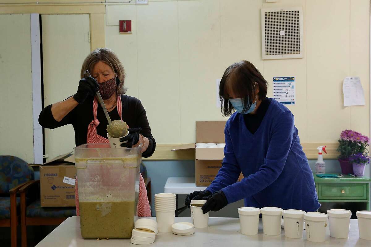 Anne Hatch (l to r) and Winnie Chu, both Food Runner volunteers, prepare food for delivery as they work in the new Food Runners’ kitchen at the Waller Center in San Franciscon Monday, April 20, 2020 in San Francisco, Calif.