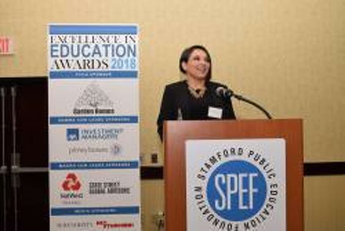 Ellie Kousidis, a library media specialist at Rippowarm Middle School, accepts the 2018 Stamford Public Education Foundation award at the Excellence in Education Awards Celebration in Stamford, Conn. on March 22, 2018.