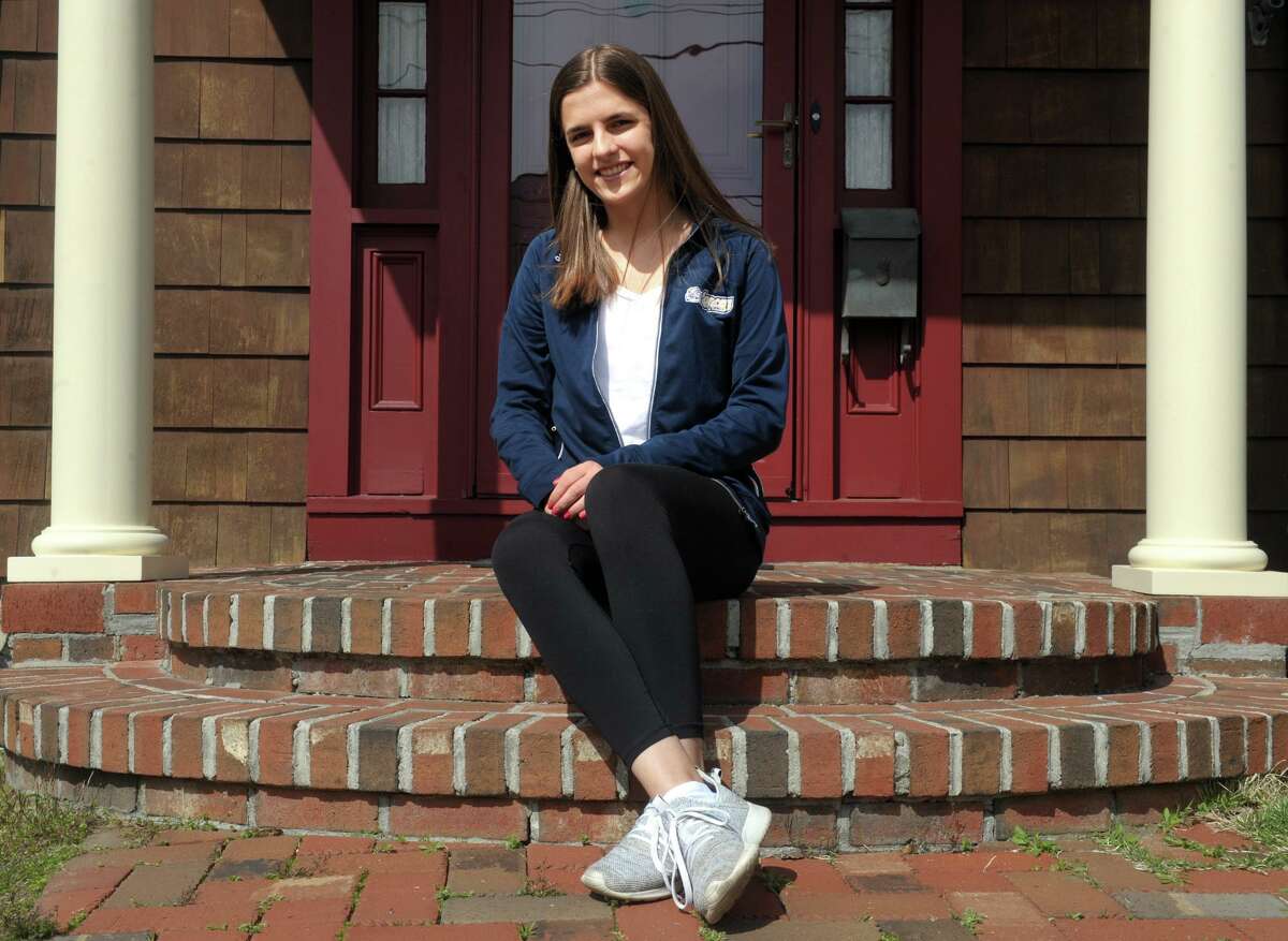 Sarah Sportini poses on the front porch of her home in Stratford last week.. Currently a junior at Notre Dame High School in Fairfield, Sportini has not been able to visit the several of the college campuses where she hope to apply.
