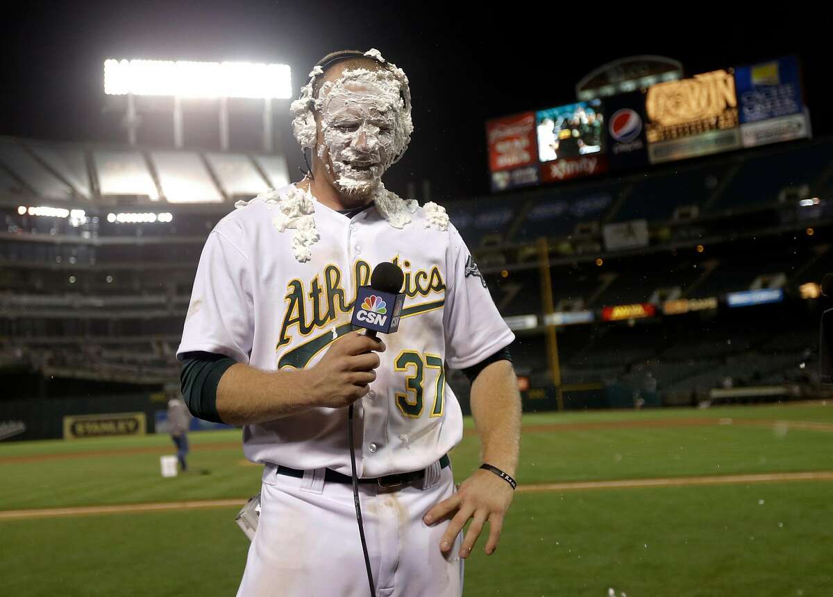 Oakland Athletics' Brandon Moss gets a shaving cream pie to the face as he conducts an interview after his game winning two-run home run against the Los Angeles Angels during a baseball game on Tuesday, April 30, 2013 in Oakland. Calif. Oakland won 10-8 in 19 innings. It was the longest game ever played in Oakland — and the longest in Angels history. (AP Photo/Marcio Jose Sanchez)